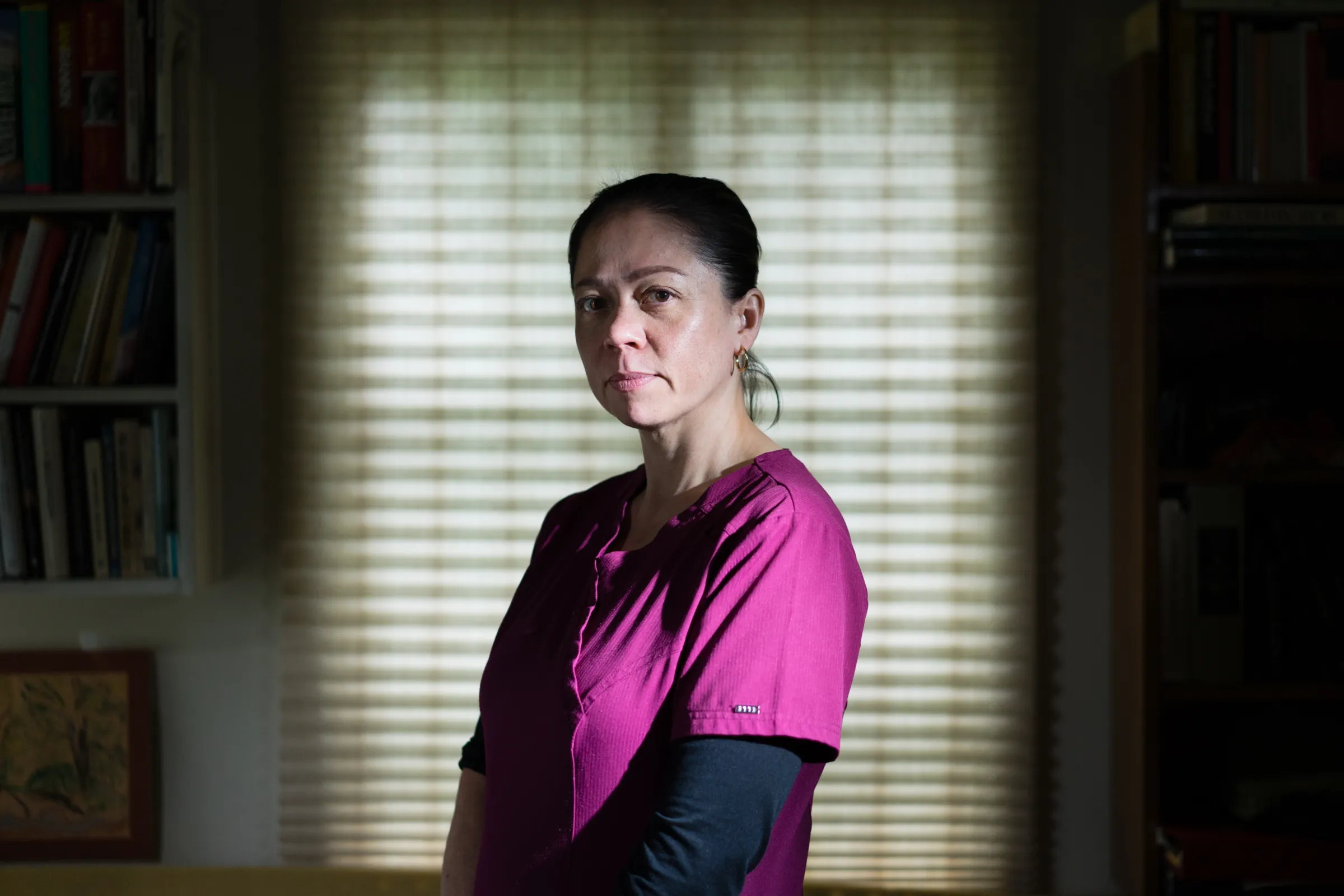 Portrait of a woman named Julie Riduta, in scrubs.